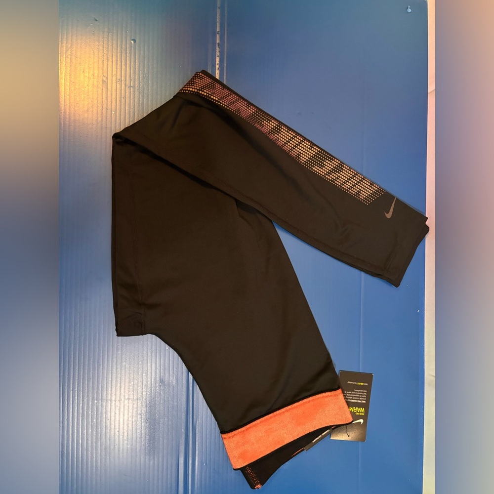 Nike Black Leggings with Orange Hem and Perforated Calf Accents